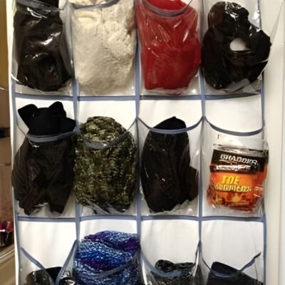The Ultimate Household Organizer Hanging Shoe Sorter features clear pockets to neatly hold bags of powders, clothing, colorful fabrics, and packaged snacks.
