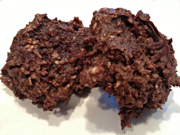 two chocolate protein cookies on a white background