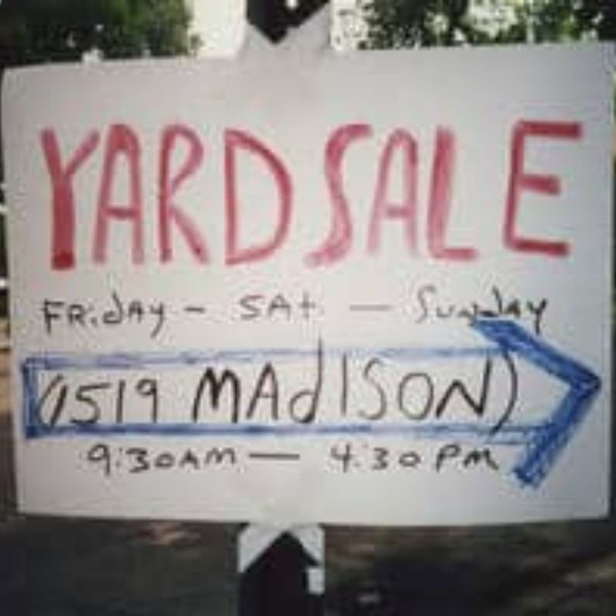Handwritten yard sale sign reads: "Yard Sale Friday - Sat - Sunday 1519 Madison 9:30am - 4:30pm" with an arrow pointing right—don’t miss out and pick up some tips for a successful yard sale while you shop!.