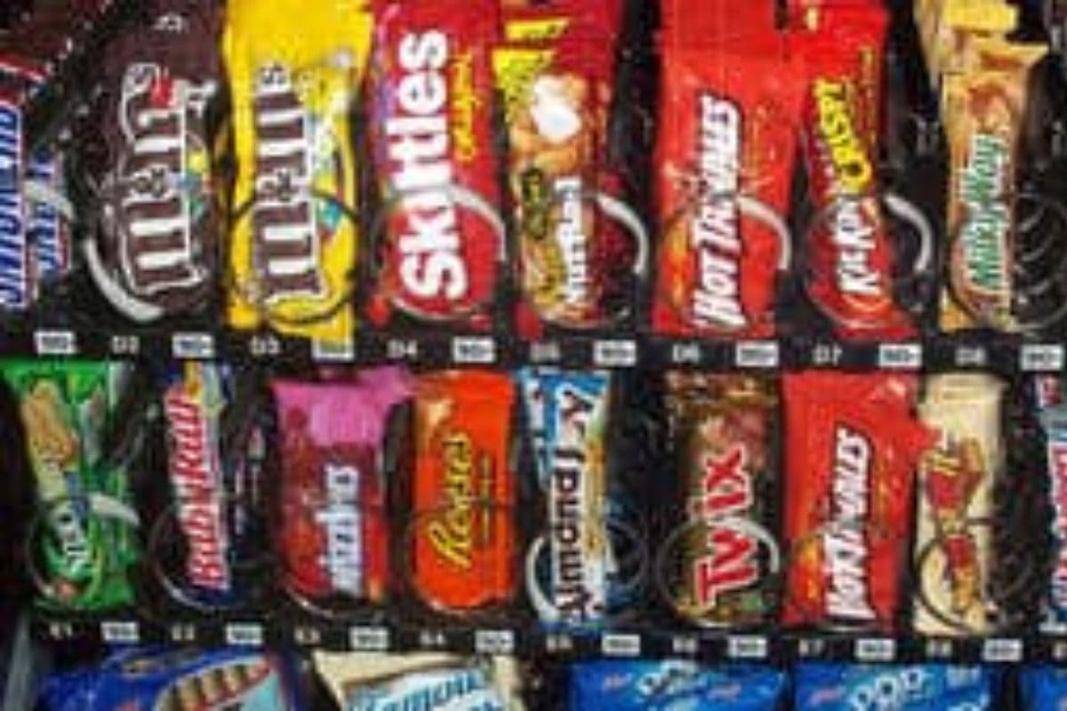 A vending machine with various candy bars and snacks.