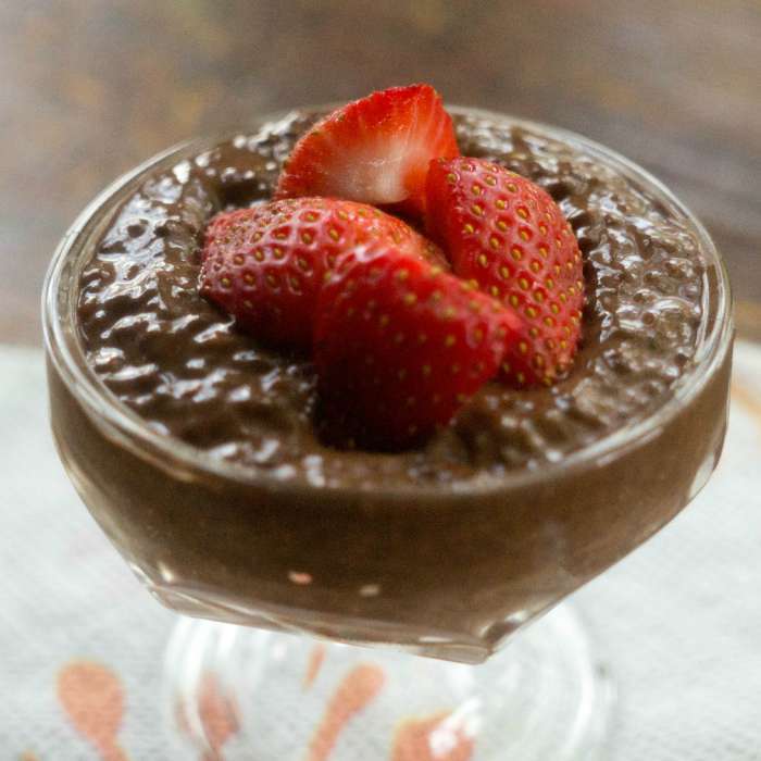 chocolate chia pudding topped with sliced strawberries