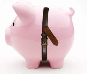saving money with pig wearing a belt