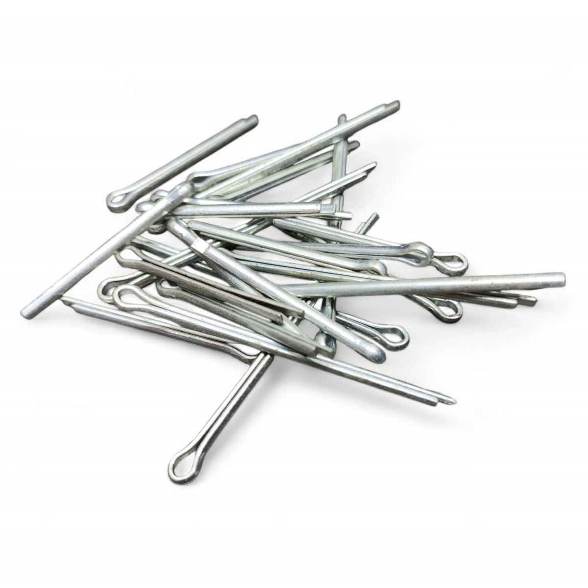 A pile of silver metal cotter pins, perfect for crafty uses for cotter pins, arranged randomly on a white background.