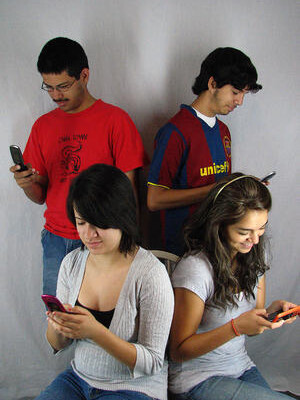 four kids on their phones