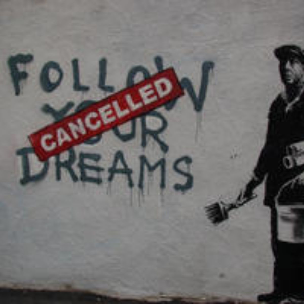 Graffiti on a wall says "Follow Your Dreams" with a gold "Cancelled" sign pasted over it; a person holding a paintbrush and bucket stands to the right.