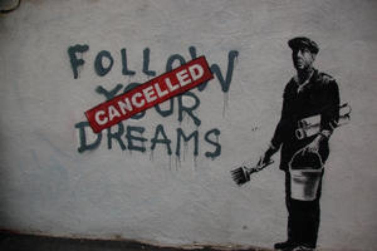A mural shows the words "FOLLOW YOUR DREAMS" with "CANCELLED" stamped over it in bold red, next to a figure of a painter holding gold tools.