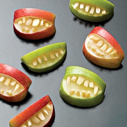 Apples decorated to look like mouth with teeth
