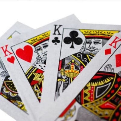 Four playing cards are shown: the king of spades, king of hearts, king of clubs, and king of diamonds, fanned out on a white background—perfect for fun card games.