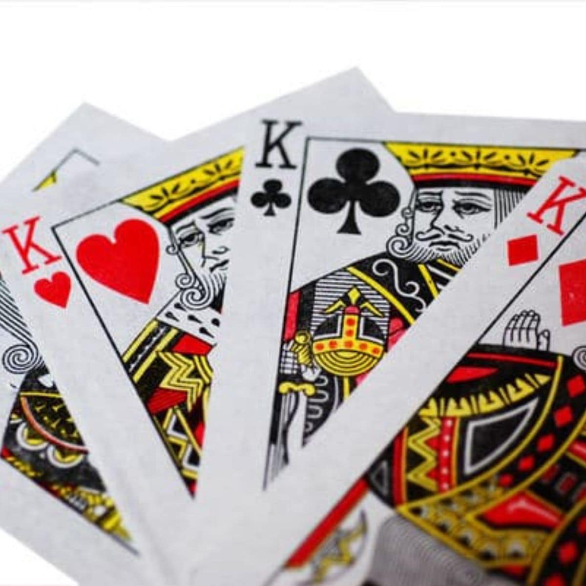 Four playing cards are shown: the king of spades, king of hearts, king of clubs, and king of diamonds, fanned out on a white background—perfect for fun card games.