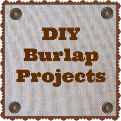 Text reading "DIY Burlap Projects" in bold brown letters on a burlap background, bordered with scalloped edges and metal brads at the corners—perfect inspiration for your next diy burlap projects.