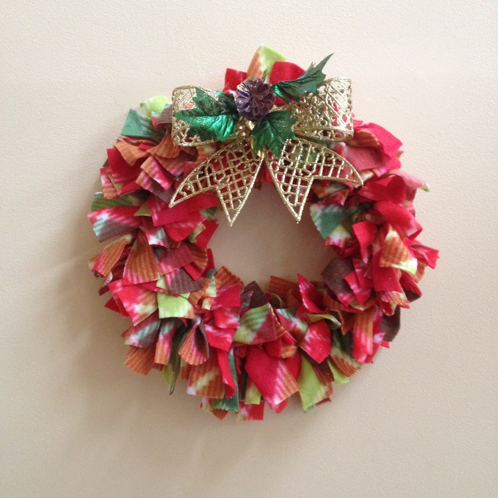red and green fleece Christmas Wreath with a gold bow