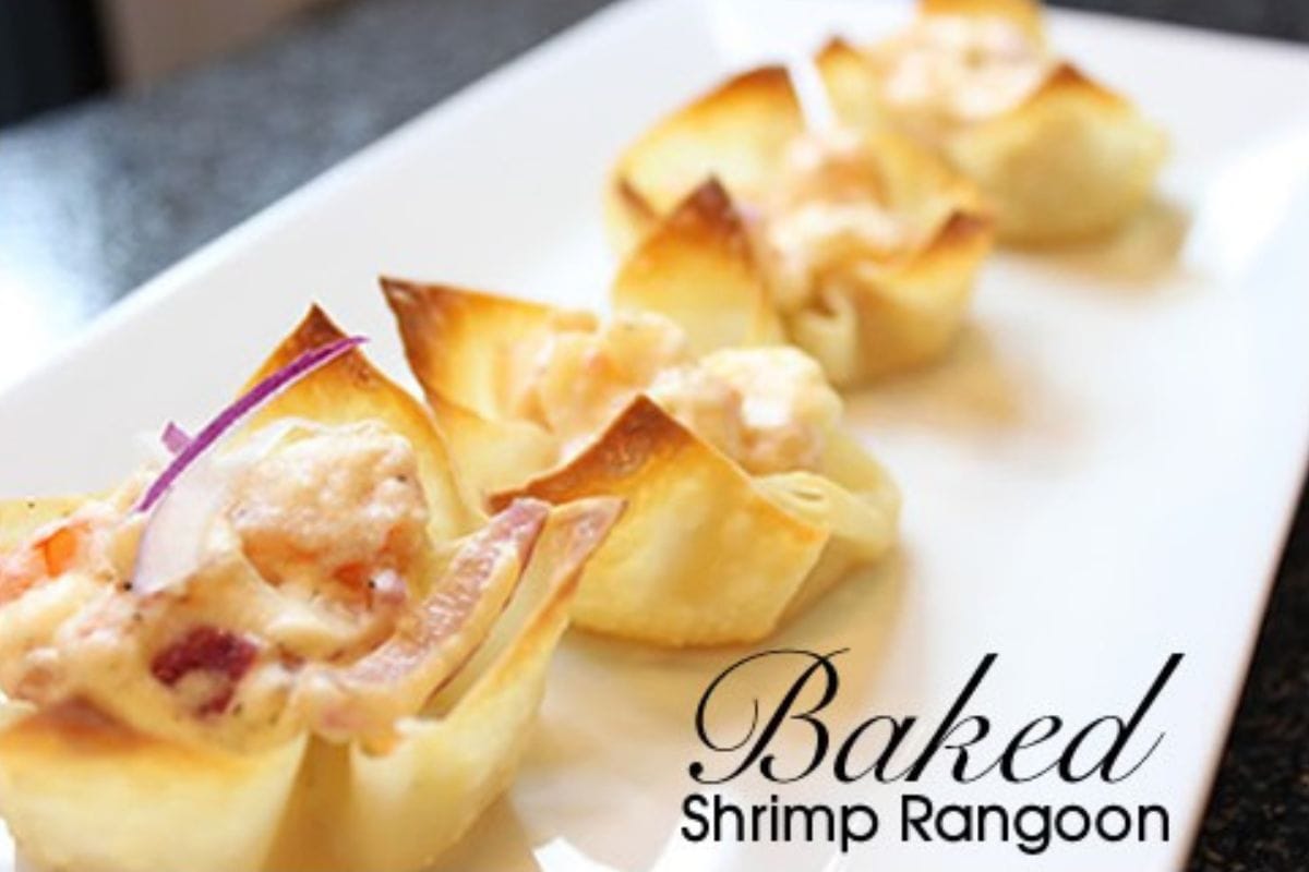 Four baked shrimp rangoon appetizers on a white rectangular plate, with text reading