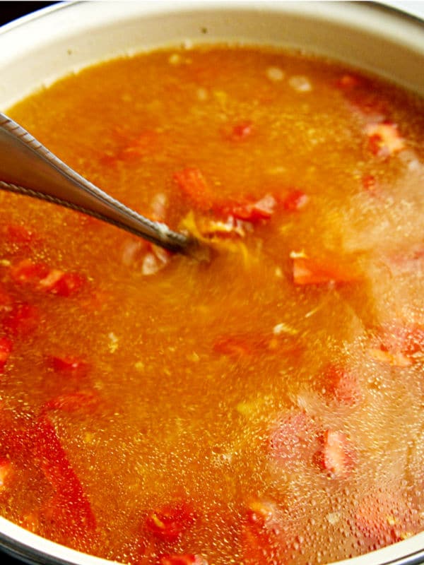  tex mex chicken soup being stirred with a spoon in a pot