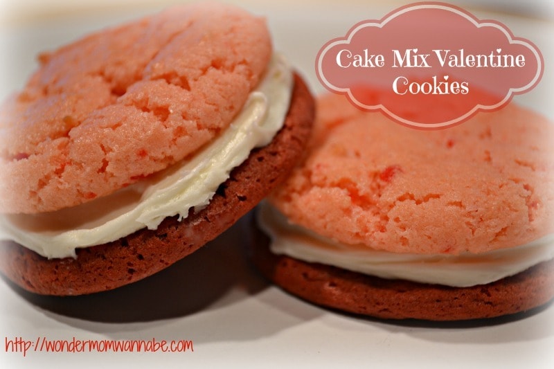 two pink cookies with frosting in the middle with title text reading Cake Mix Valentine Cookies