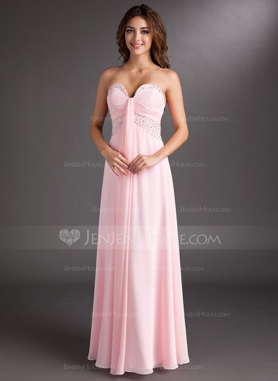 a lady wearing a pink sweetheart prom dress
