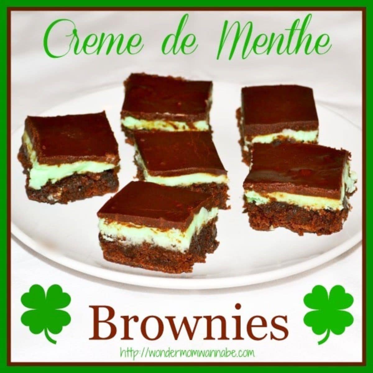 A white plate holds six creme de menthe brownies, each topped with chocolate and a vibrant green mint layer, labeled "Creme de Menthe Brownies" and adorned with clover graphics along the border.