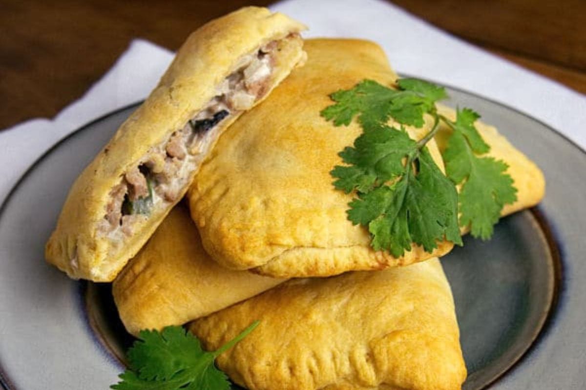 Turkey turnovers stacked on a plate.