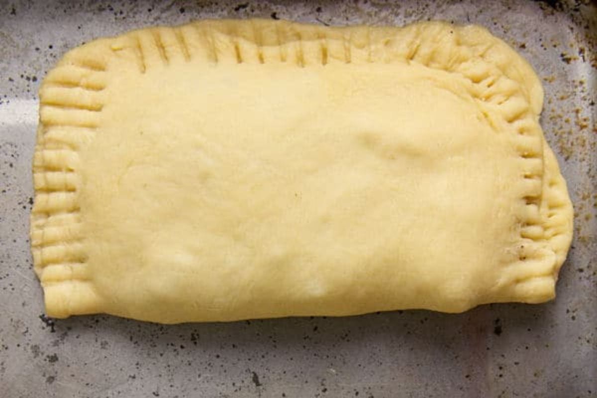 Ground turkey turnovers on a baking sheet.