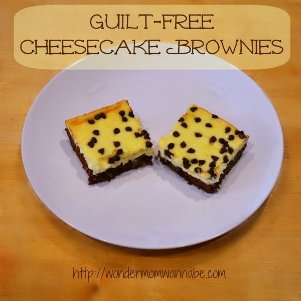 two Cheesecake Brownies on a white plate on a brown table with title text reading Guilt-Free Cheesecake Brownies