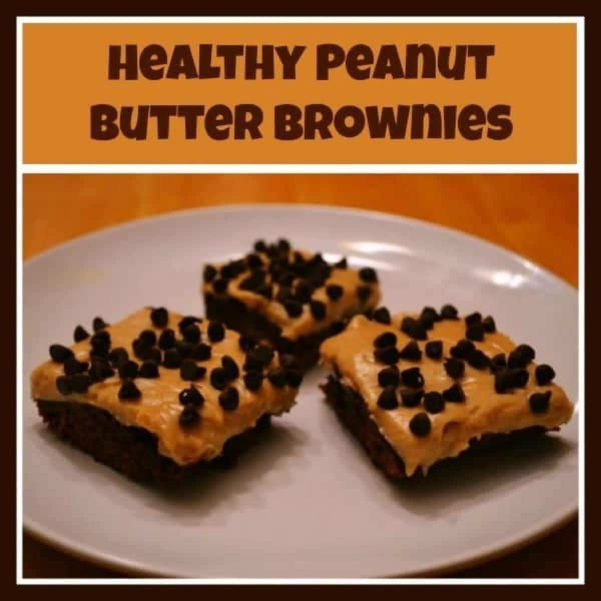 Three healthy peanut butter brownies topped with chocolate chips are arranged on a white plate, with the text "Healthy Peanut Butter Brownies" above the image.