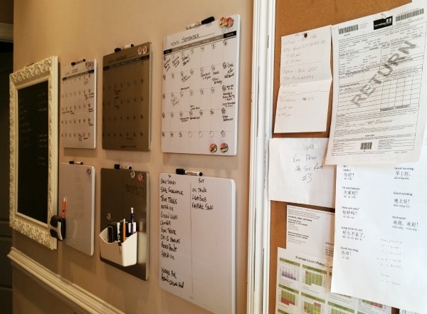 family command center with calendars and dry erase boards on the wall