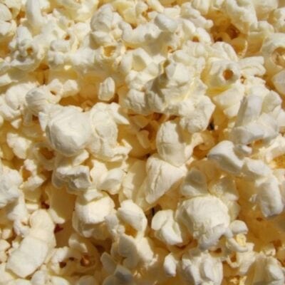A close-up view of several pieces of freshly popped popcorn, perfect for trying out new popcorn topping ideas.