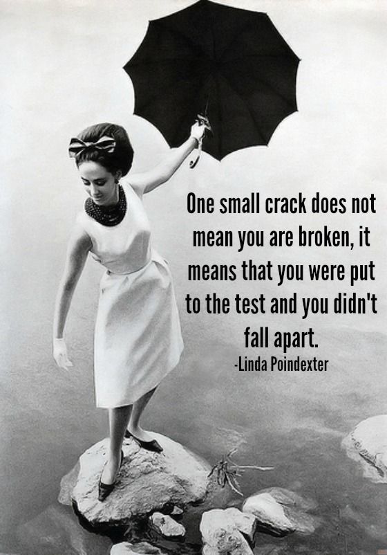 a lady holding an umbrella standing on a rock in the water with text reading One small crack does not mean you are broken, it means that you were put to the test and you didn't fall apart.
