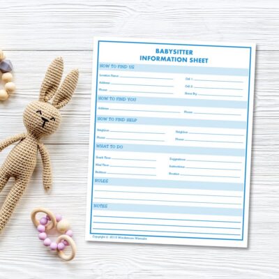 Babysitter information sheet on a white wooden surface, placed beside a knitted bunny toy and two beaded teething rings—perfect for organizing essential babysitter information at a glance.