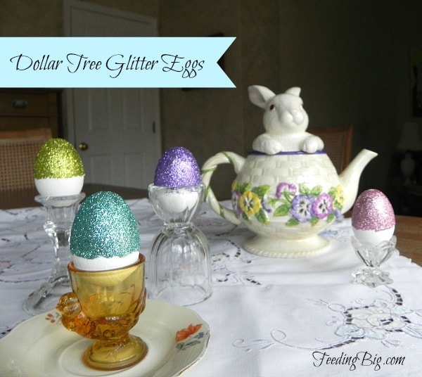 Dollar-Tree-Glitter-Eggs on a tablecloth next to a bunny teapot