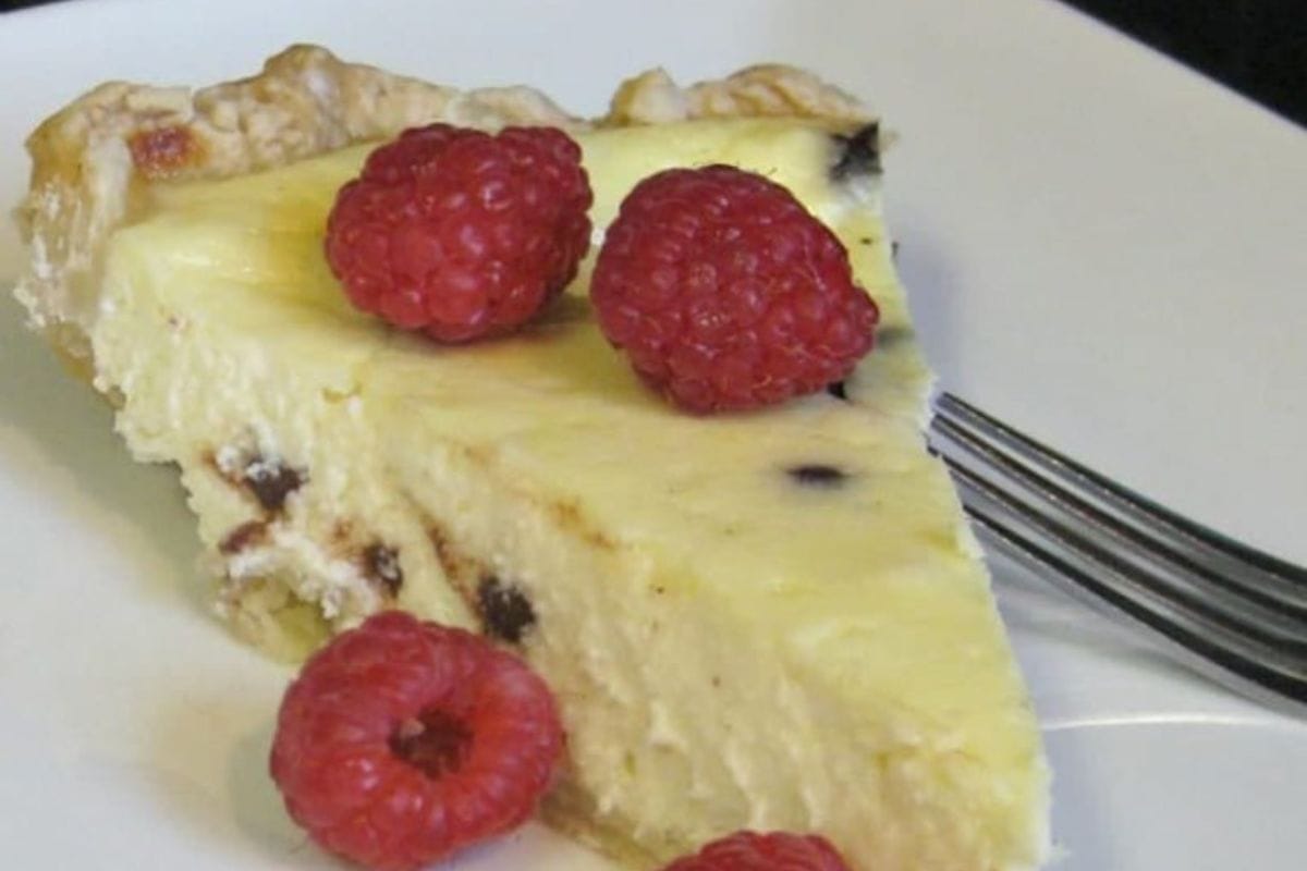 Cannoli-Pie on a white plate with a fork next to it.