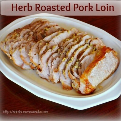 Herb roasted pork loin on white serving dish