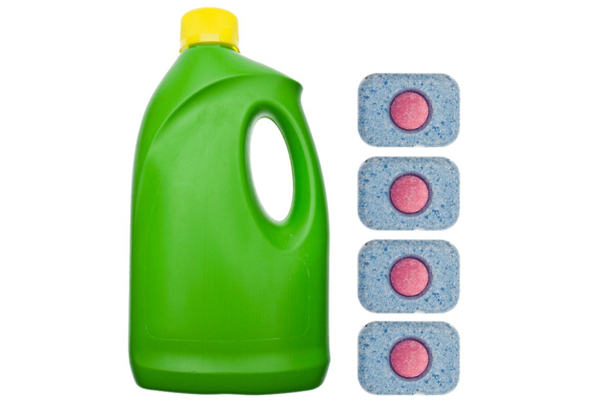 A green plastic bottle with a yellow cap sits next to four blue and pink dishwasher tablets on a white background, highlighting other uses for dishwasher pods beyond cleaning dishes.