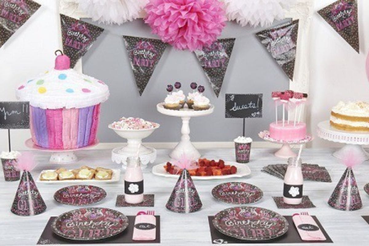 A birthday party table is decorated with