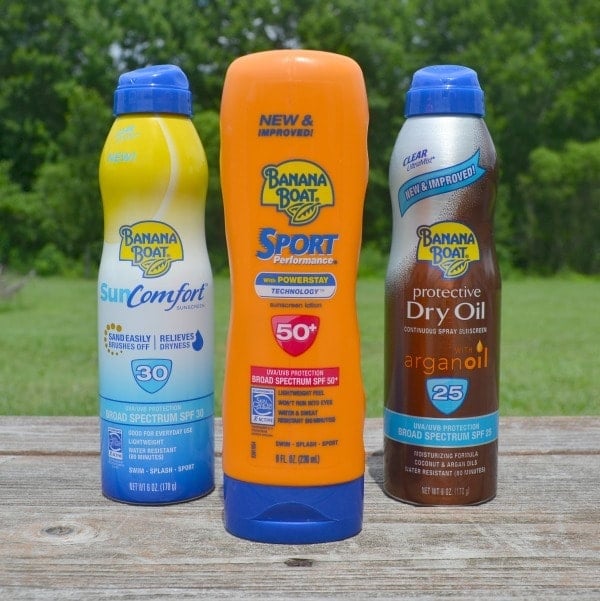 three varieites of Banana Boat Sunscreen on a wood table outside