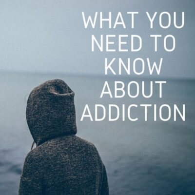 Person in a hooded sweater faces a body of water; large text reads, "What You Need to Know About Addiction," highlighting key information and insights on understanding addiction.