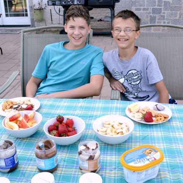 Boys smiling with a table of snacks
