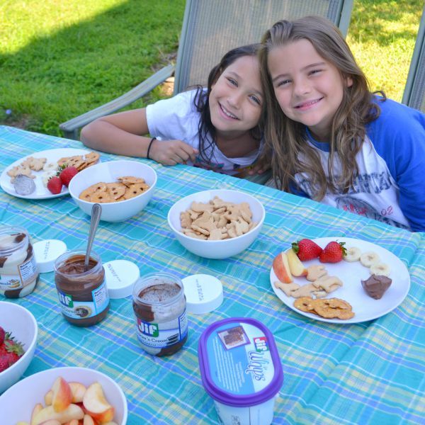 Girls smiling with a table of snacks