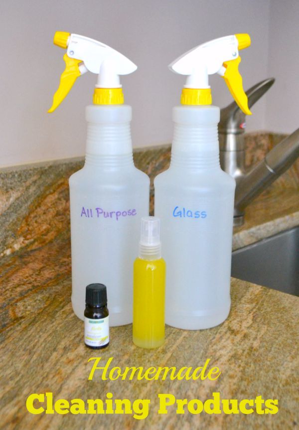 spray bottles labeled all purpose and glass next to an essential oil and a smaller bottle with title text reading Homemade Cleaning Products