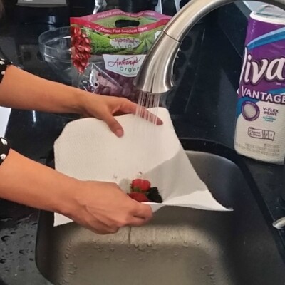Cleaning fruit in the sink, on a paper towel