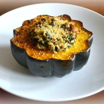 Sausage Spinach and Brown Rice Stuffed Acorn Squash on white plate