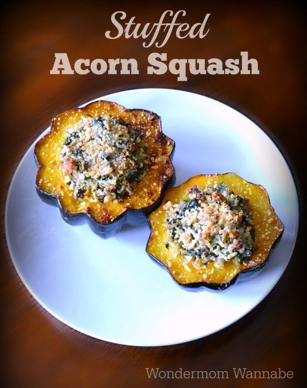 Stuffed Acorn Squash on a white plate on a brown table with title text reading Stuffed Acorn Squash