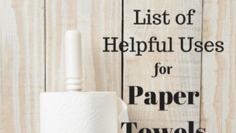 A paper towel roll on a holder stands in front of a wooden background with text that reads, "The Ultimate List of Helpful Uses for Paper Towels." Discover creative and practical uses for paper towels in your daily life.