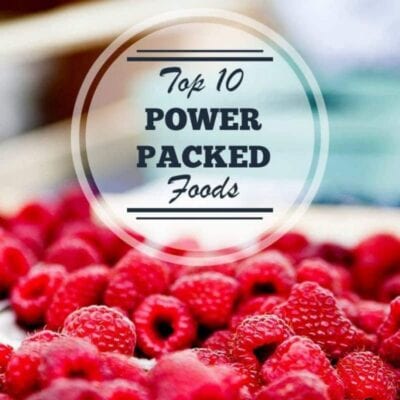 A close-up of fresh raspberries with a circular overlay text that reads, "Top 10 Power Packed Foods," highlighting these vibrant berries as one of the ultimate power packed foods for your diet.