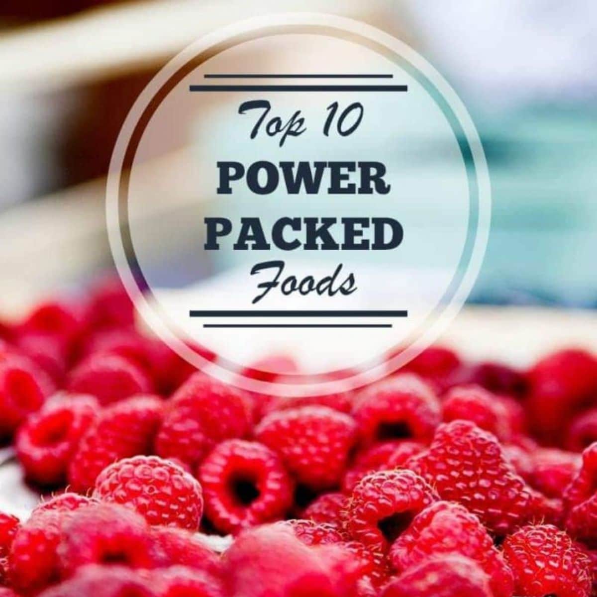 A close-up of fresh raspberries with a circular overlay text that reads, "Top 10 Power Packed Foods," highlighting these vibrant berries as one of the ultimate power packed foods for your diet.