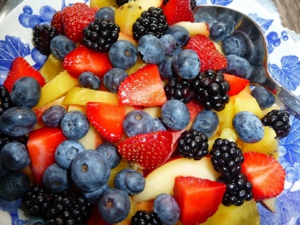 various fruits on a blue and white plate