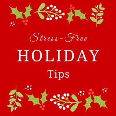 Red graphic with green holly and white berries framing the text, "Stress-Free Holiday Tips," in white—perfect for sharing your favorite stress free holiday tips this season.