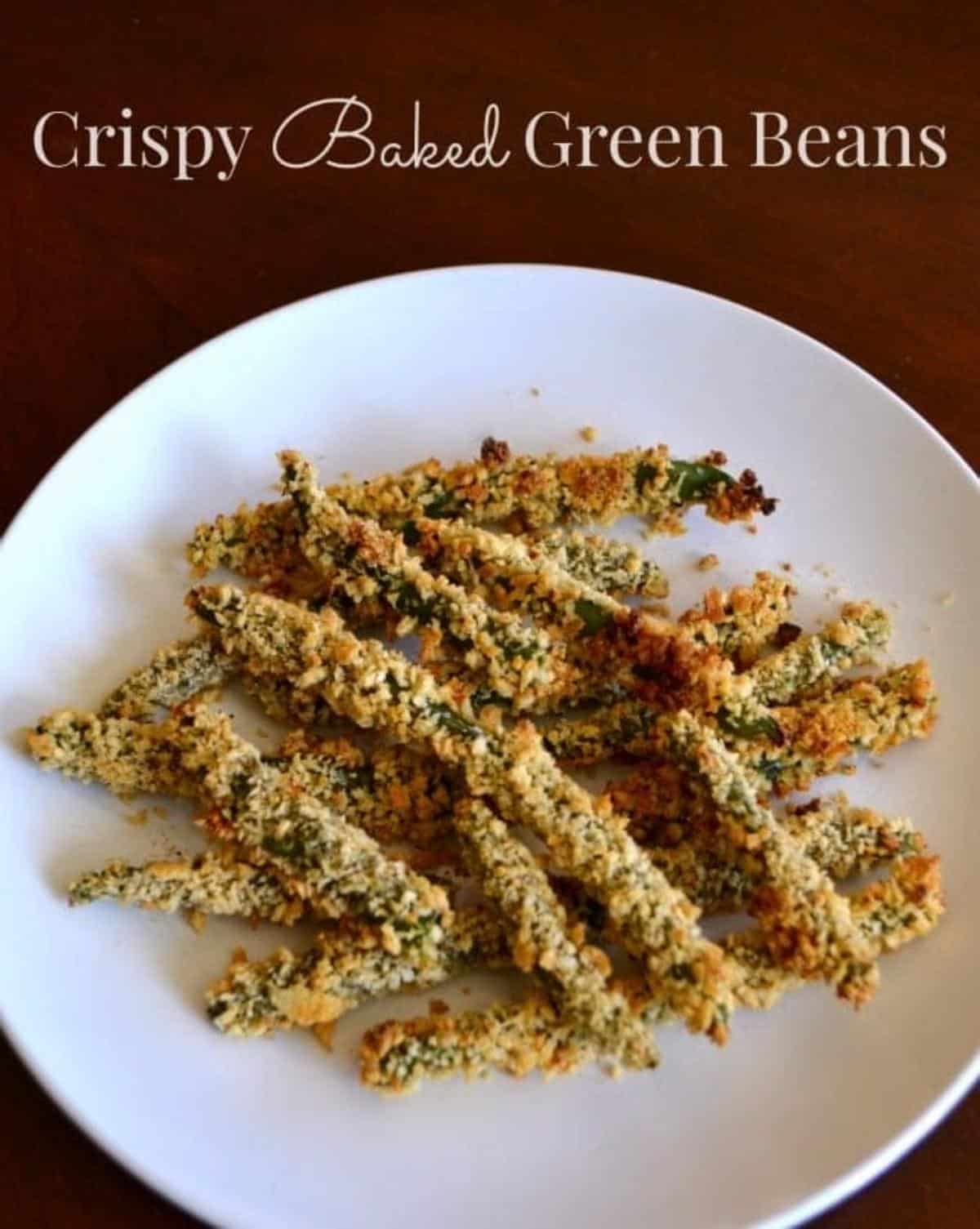 Crispy baked green beans on a plate with text title Crispy Baked Green Beans.
