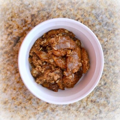 Paleo Apple Crisp and Caramel Sauce in white bowl
