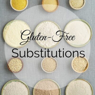 Bowls of various gluten-free flours and grains are arranged on a gray surface, highlighting smart gluten-free substitutions with the text “Gluten-Free Substitutions” overlaid.