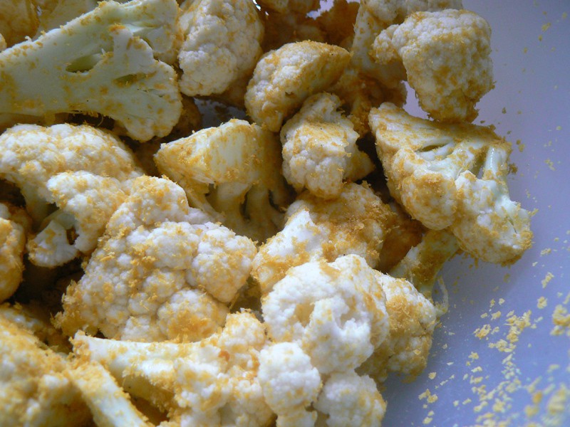 cauliflower mixed with nutritional yeast and olive oil